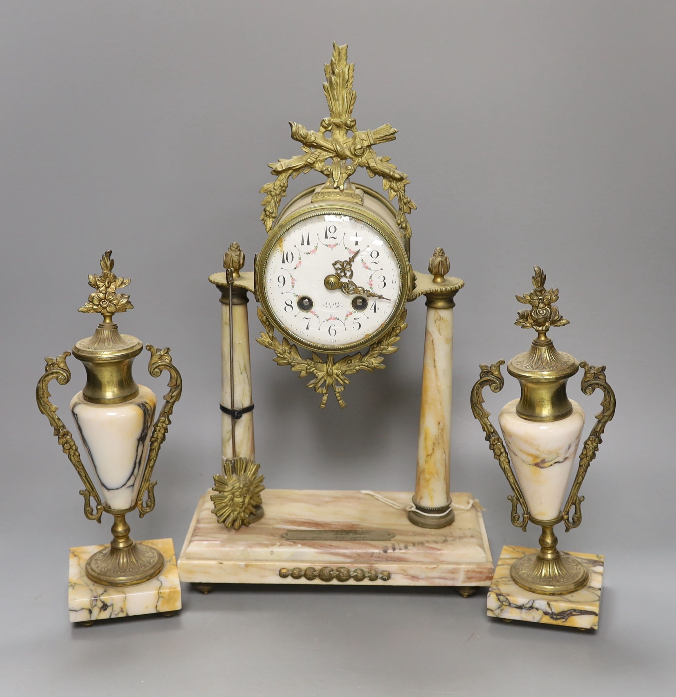 A French three-piece marble and gilt metal clock garniture, pendulum, no winder. 42cm